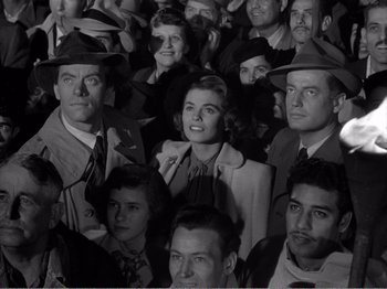 Movie still from “All the King's Men” (1949), directed by Robert Rossen – A group of people that are standing up together; Medium shot, High angle