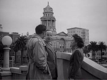 Movie still from “All the King's Men” (1949), directed by Robert Rossen – A group of people standing on top of a building; Medium shot, Low angle