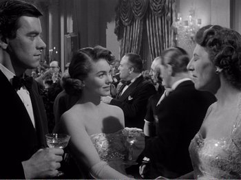 Movie still from “All the King's Men” (1949), directed by Robert Rossen – A black and white photo of a group of people at an event; Medium shot, Over the shoulder angle