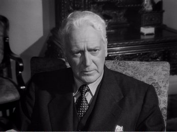 Movie still from “All the King's Men” (1949), directed by Robert Rossen – An older man wearing a suit and tie; Close Up shot, Low angle
