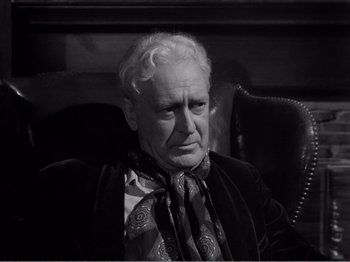 Movie still from “All the King's Men” (1949), directed by Robert Rossen – An older man sitting in a chair wearing a neck tie; Close Up shot, High angle