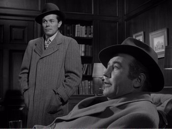 Movie still from “All the King's Men” (1949), directed by Robert Rossen – A man in a hat and a man in a suit and tie; Medium shot, Over the shoulder angle