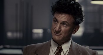 Movie still from “All the King's Men” (2006), directed by Steven Zaillian – A person wearing a suit and tie; Close Up shot, Over the shoulder angle