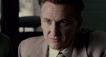 Movie still from “All the King's Men” (2006), directed by Steven Zaillian – A person wearing a suit and tie; Close Up shot, Over the shoulder angle