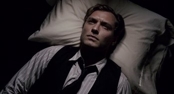 Movie still from “All the King's Men” (2006), directed by Steven Zaillian – A man laying in bed wearing a vest and tie; Close Up shot, High angle