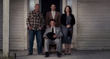 Movie still from “All the King's Men” (2006), directed by Steven Zaillian – A group of men and women standing in front of a building; Wide shot, Low angle