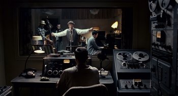 Movie still from “All the King's Men” (2006), directed by Steven Zaillian – A group of people in a recording studio; Wide shot, Over the shoulder angle