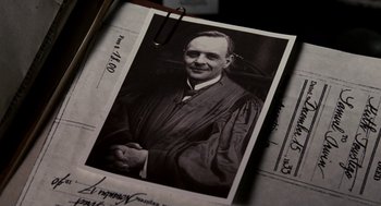 Movie still from “All the King's Men” (2006), directed by Steven Zaillian – An old photo of a man wearing a robe; Extreme Close Up shot, High angle