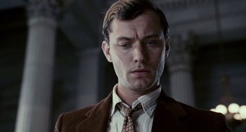 Movie still from “All the King's Men” (2006), directed by Steven Zaillian – A person wearing a suit and tie; Close Up shot, Low angle