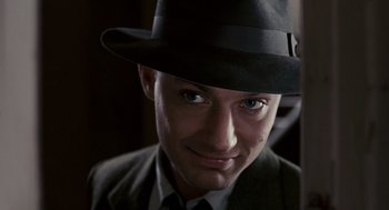 Movie still from “All the King's Men” (2006), directed by Steven Zaillian – A person wearing a suit and a hat; Close Up shot, High angle