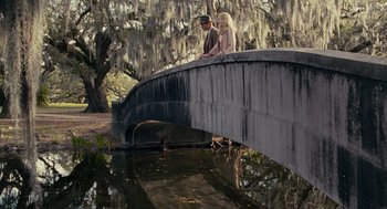 Movie still from “All the King's Men” (2006), directed by Steven Zaillian – A man and a woman standing on a bridge over a river; Wide shot, High angle