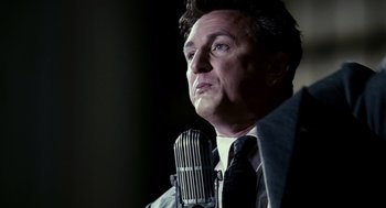 Movie still from “All the King's Men” (2006), directed by Steven Zaillian – A man with a microphone in his hand; Close Up shot, Low angle