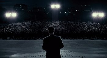 Movie still from “All the King's Men” (2006), directed by Steven Zaillian – A man standing in front of an audience at night; Extreme Wide shot, High angle