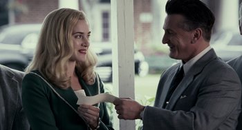 Movie still from “All the King's Men” (2006), directed by Steven Zaillian – A man and a woman holding a piece of paper; Medium shot, Over the shoulder angle