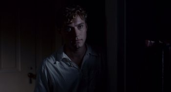 Movie still from “All the King's Men” (2006), directed by Steven Zaillian – A young man is standing in the dark; Close Up shot, Over the shoulder angle