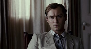 Movie still from “All the King's Men” (2006), directed by Steven Zaillian – A person sitting in a chair wearing a suit; Close Up shot, Low angle