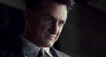 Movie still from “All the King's Men” (2006), directed by Steven Zaillian – A person wearing a suit and tie; Close Up shot, Low angle