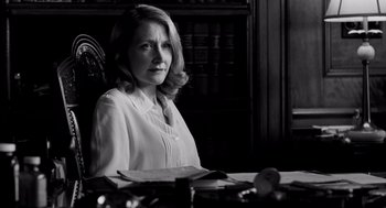 Movie still from “All the King's Men” (2006), directed by Steven Zaillian – Black and white photograph of a woman sitting at a desk; Medium shot, Low angle