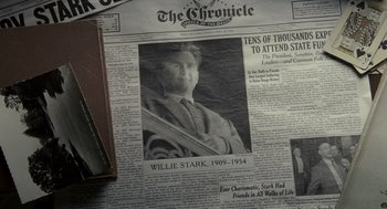 Movie still from “All the King's Men” (2006), directed by Steven Zaillian – A newspaper with a picture of a man on it; Extreme Close Up shot, Overhead angle