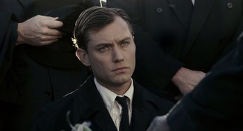Movie still from “All the King's Men” (2006), directed by Steven Zaillian – A person wearing a suit and tie; Close Up shot, Over the shoulder angle