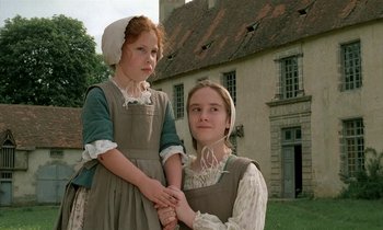 Movie still from “Tous les matins du monde” (1991), directed by Alain Corneau – Two young girls dressed in period clothing pose for a picture; Medium shot, Low angle