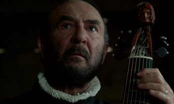 Movie still from “Tous les matins du monde” (1991), directed by Alain Corneau – An old man with a beard and a mustache holding a guitar; Close Up shot, Low angle