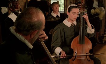 Movie still from “Tous les matins du monde” (1991), directed by Alain Corneau – A group of people playing musical instruments in a room; Medium shot, Over the shoulder angle