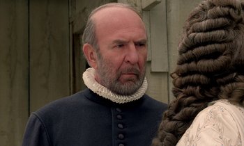 Movie still from “Tous les matins du monde” (1991), directed by Alain Corneau – An older man with a beard wearing a black jacket; Close Up shot, Over the shoulder angle