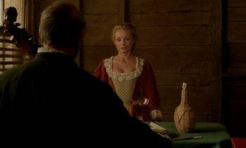 Movie still from “Tous les matins du monde” (1991), directed by Alain Corneau – A woman is sitting at a table with a man; Medium shot, Over the shoulder angle
