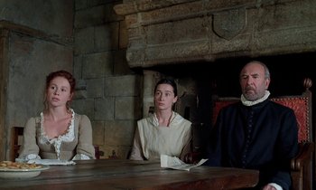 Movie still from “Tous les matins du monde” (1991), directed by Alain Corneau – A group of people sitting at a wooden table; Medium shot, High angle