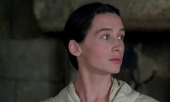 Movie still from “Tous les matins du monde” (1991), directed by Alain Corneau – A person wearing a white shirt looking to the side; Close Up shot, Low angle