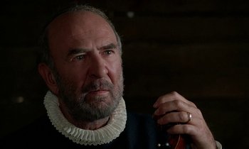 Movie still from “Tous les matins du monde” (1991), directed by Alain Corneau – An older man with a beard wearing a white collar; Close Up shot, Over the shoulder angle