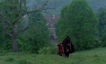 Movie still from “Tous les matins du monde” (1991), directed by Alain Corneau – Two people walking through a lush green field; Extreme Wide shot, High angle