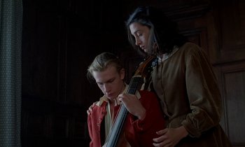 Movie still from “Tous les matins du monde” (1991), directed by Alain Corneau – A man and a woman are holding a guitar; Medium shot, Low angle