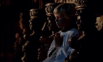 Movie still from “Tous les matins du monde” (1991), directed by Alain Corneau – A little girl in a white dress is praying; Medium shot, High angle