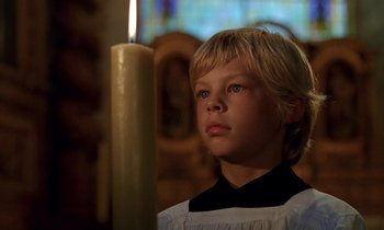 Movie still from “Tous les matins du monde” (1991), directed by Alain Corneau – A young boy is standing in front of a lit candle; Close Up shot, Low angle