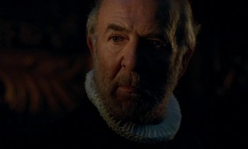 Movie still from “Tous les matins du monde” (1991), directed by Alain Corneau – An old man with a beard wearing a white collar; Close Up shot, Over the shoulder angle