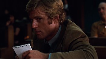 Movie still from “All the President's Men” (1976), directed by Alan J. Pakula – A person holding a paper; Close Up shot, Over the shoulder angle