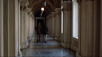 Movie still from “All the President's Men” (1976), directed by Alan J. Pakula – Two people are walking down a long hallway; Extreme Wide shot, High angle