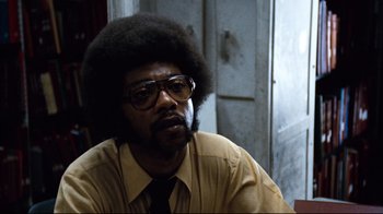 Movie still from “All the President's Men” (1976), directed by Alan J. Pakula – A man with a beard and glasses sitting in a room; Close Up shot, Over the shoulder angle