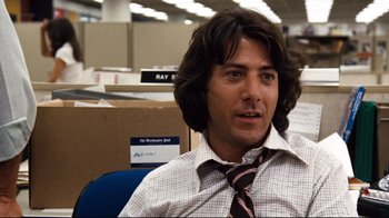 Movie still from “All the President's Men” (1976), directed by Alan J. Pakula – A man sitting in an office chair wearing a tie; Close Up shot, Low angle