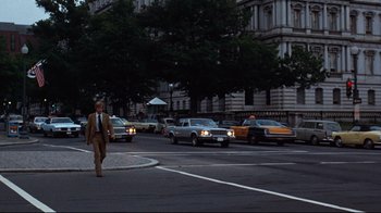 Movie still from “All the President's Men” (1976), directed by Alan J. Pakula – A man in a suit crossing the street at night; Wide shot, Low angle
