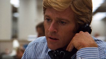 Movie still from “All the President's Men” (1976), directed by Alan J. Pakula – A person talking on a cell phone; Close Up shot, Low angle