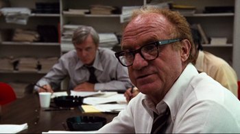 Movie still from “All the President's Men” (1976), directed by Alan J. Pakula – A man sitting at a table in front of another man; Close Up shot, Over the shoulder angle