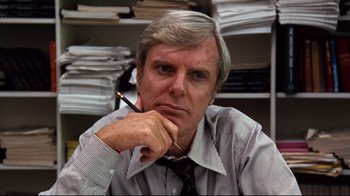 Movie still from “All the President's Men” (1976), directed by Alan J. Pakula – An older man is sitting in front of papers; Close Up shot, Low angle