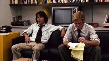 Movie still from “All the President's Men” (1976), directed by Alan J. Pakula – Two men sitting on a couch looking at papers; Medium shot, Low angle