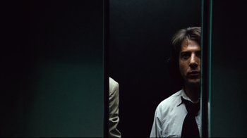 Movie still from “All the President's Men” (1976), directed by Alan J. Pakula – A man wearing a tie standing in front of a mirror; Close Up shot, Low angle
