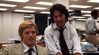 Movie still from “All the President's Men” (1976), directed by Alan J. Pakula – Two men in suits sitting in an office setting; Medium shot, Low angle