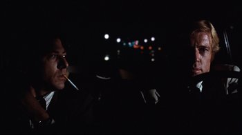 Movie still from “All the President's Men” (1976), directed by Alan J. Pakula – A man smoking a cigarette in the dark; Close Up shot, Low angle