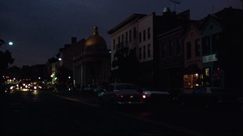 Movie still from “All the President's Men” (1976), directed by Alan J. Pakula – Cars are driving down a street at night; Extreme Wide shot, Low angle